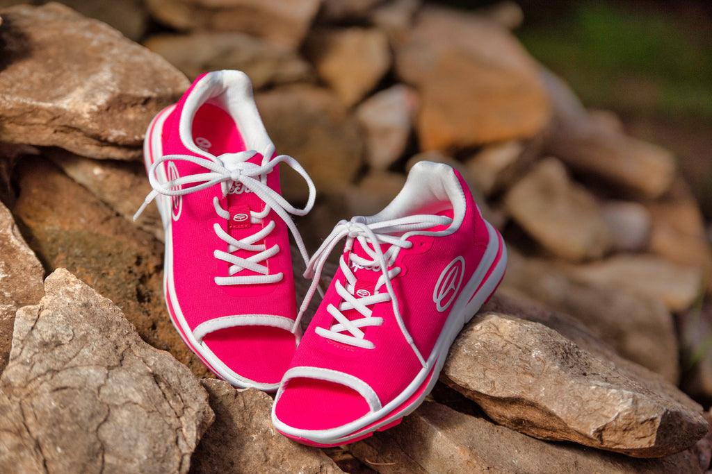 Pair of pink OpeToz open-toed athletic shoes photographed on rocks